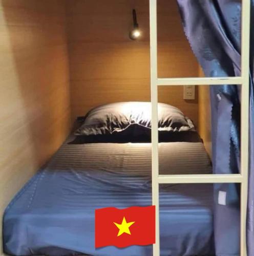 a bedroom with a bunk bed with a flag on it at Home 33 in Sapa