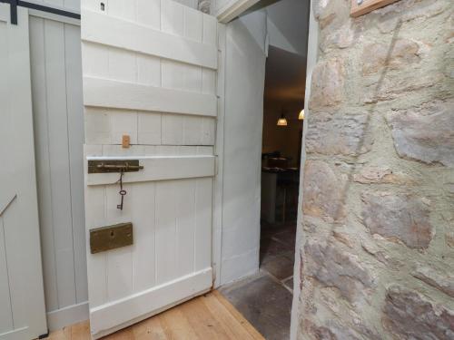 a door in a room with a stone wall at The Old Coach House in Alnwick