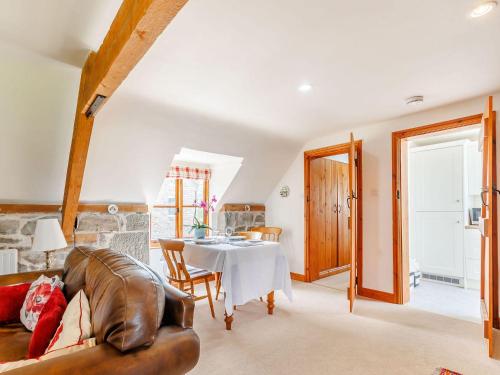 a living room with a table and a couch at Robin's Nest in Craven Arms