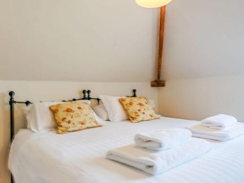 a bedroom with a bed with towels on it at Robin's Nest in Craven Arms