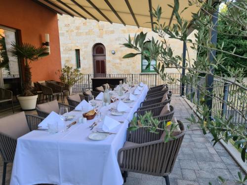 a long table in a restaurant with white tables and chairs at Schlosshotel Blankenburg in Blankenburg