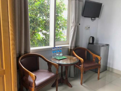 a table and two chairs with water bottles on it at Quynh Long Villa in Hoi An