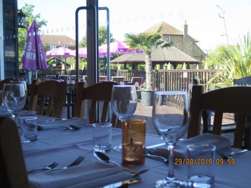 a table with wine glasses on top of it at Oyster Fleet Hotel in Canvey Island
