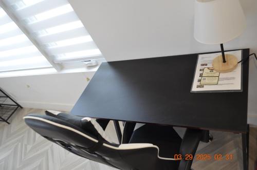 a black desk with a black chair under it at Dimond Abode Vacation Home #2 Oakland Dimond District in Oakland