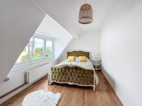 a bedroom with a bed and a window at Le Blériot in Sangatte