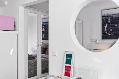a mirror in a white room with a sink at Ferienwohnung Strandliebe Laboe in Laboe