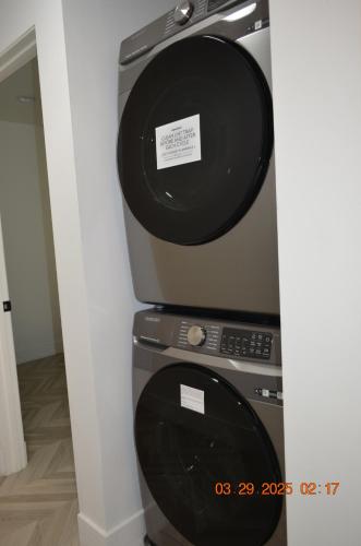 a computer monitor sitting on top of a microwave at Dimond Abode Vacation Home #2 Oakland Dimond District in Oakland