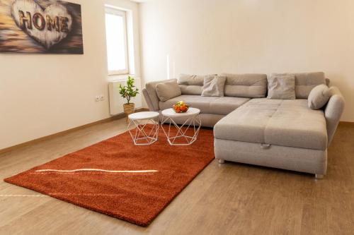 a living room with a couch and a rug at Feriendorf Slawitsch in Bad Sulza