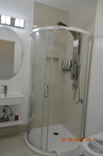 a shower with a glass door in a bathroom at Dimond Abode Vacation Home #2 Oakland Dimond District in Oakland