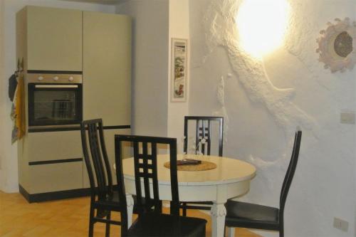 a kitchen with a table and chairs and a refrigerator at Casa Alberi in Volterra