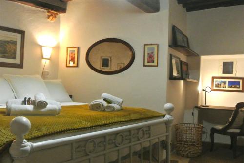 a bedroom with a bed with a mirror on the wall at Casa Alberi in Volterra