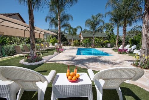 a table with fruit on it next to a pool at Song of Galilee in Elifelet
