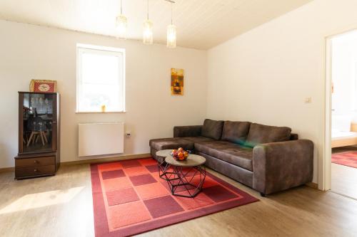 a living room with a couch and a table at Feriendorf Slawitsch in Bad Sulza