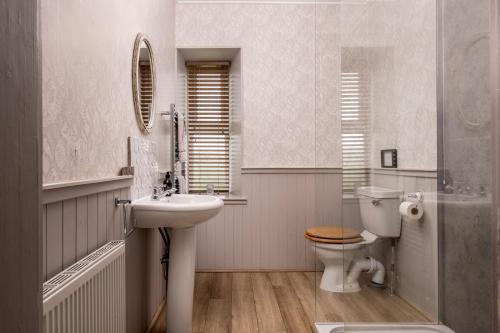 a bathroom with a sink and a toilet at Old Duffus Farmhouse in Duffus