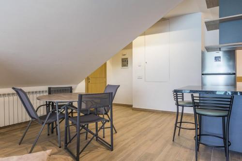 a kitchen and dining room with a table and chairs at Winter Light Kfardebian in Kfardebian