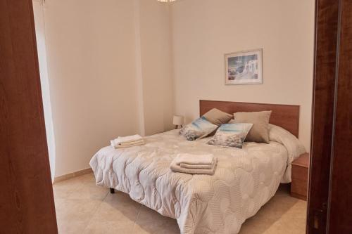 a bedroom with a bed with towels on it at La Casa di Caterina in Peschici