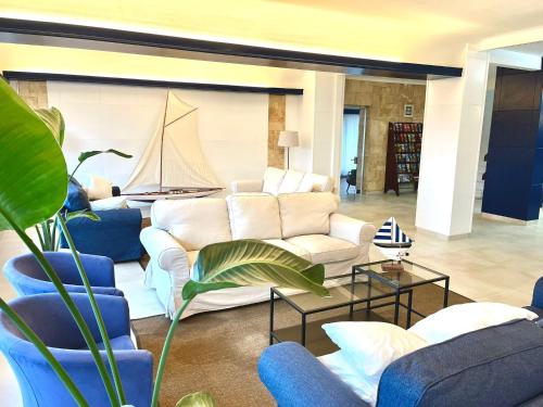a living room with a couch and a sail on the wall at Hotel Garbi in Calella de Palafrugell