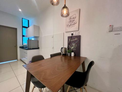 a dining room with a wooden table and chairs at ITCC Manhattan by IGVC in Penampang
