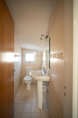 a bathroom with a sink and a toilet at Coastal Retreat Protaras in Protaras