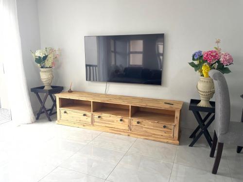 a television sitting on top of a wooden entertainment center at 2 bedroom Apartment on the Bay in Richards Bay