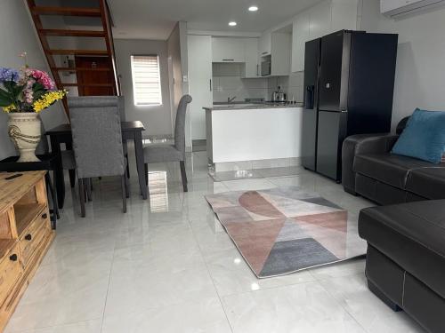 a living room with a couch and a kitchen at 2 bedroom Apartment on the Bay in Richards Bay