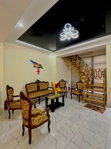 a living room with couches and a table and stairs at Hotel balcony in Kutaisi