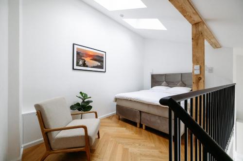 a bedroom with a bed and a chair at Hestia Hotel Barons Old Town in Tallinn