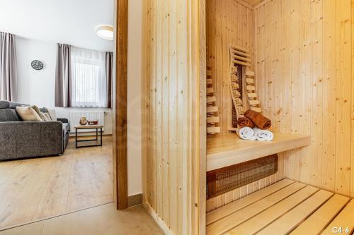 a room with a wooden wall with a wine cellar at KORZO LIPNO C in Lipno nad Vltavou