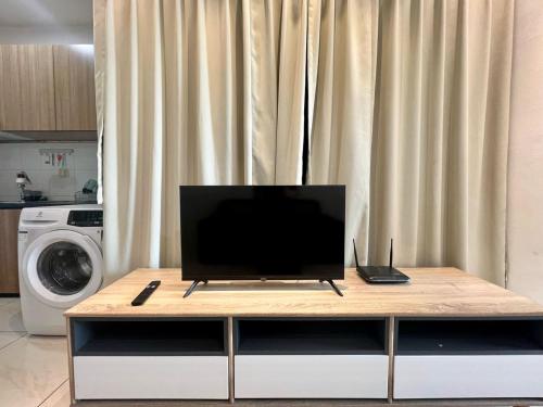 a television sitting on top of a table in a kitchen at ITCC Manhattan by IGVC in Penampang