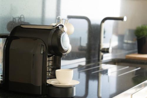 a coffee maker with a cup on a counter at Villa La Perla by LovelyStay in Paul do Mar