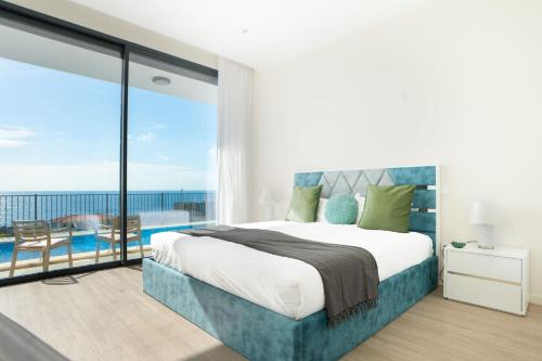 a bedroom with a large bed and a balcony at Villa La Perla by LovelyStay in Paul do Mar
