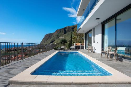 a swimming pool on a balcony with a view of the ocean at Villa La Perla by LovelyStay in Paul do Mar