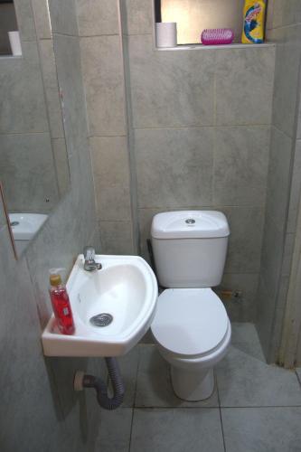 a bathroom with a toilet and a sink at Legatus Cozy Studios 3 in Ongata Rongai 
