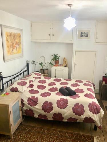 a bedroom with a bed with a floral comforter at Seafront balcony, lovely spacious relaxing flat in Hastings