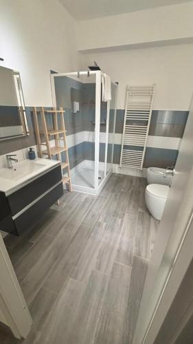 a bathroom with a sink and a toilet and a shower at Il Tiglio B&B in Borgo Montenero