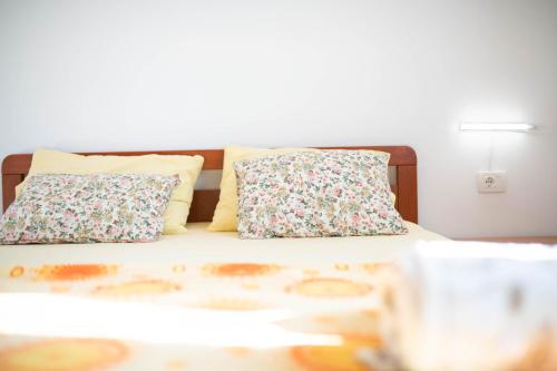 a bed with two pillows on top of it at Apartment Thomas in Novigrad Istria
