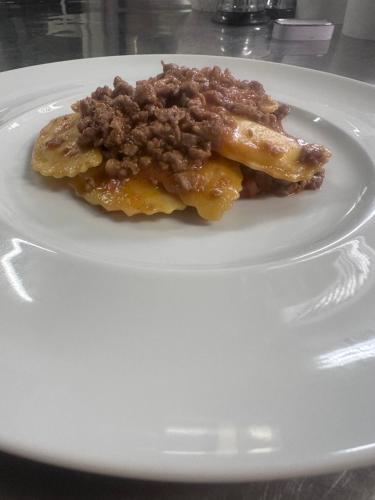 a white plate with two pieces of food on it at Hotel La Torretta in Castel San Pietro Terme