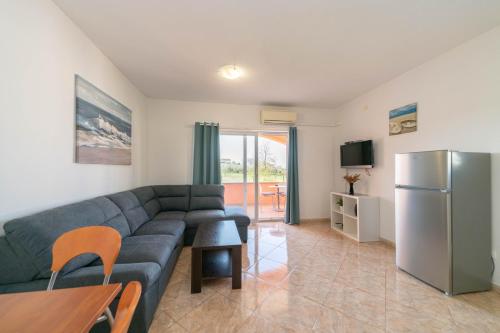 a living room with a couch and a refrigerator at Apartment Thomas in Novigrad Istria