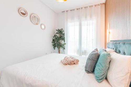 a bedroom with a bed with two pillows on it at Design Seascape apartment in Orihuela Costa