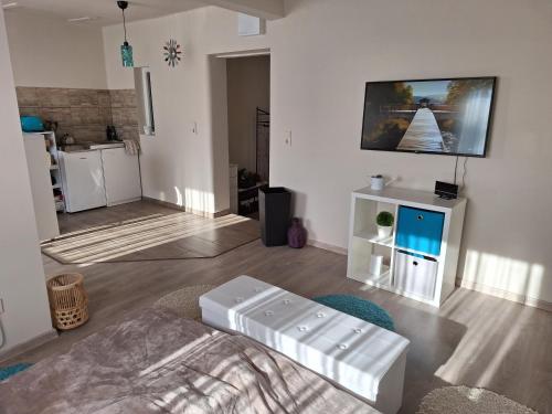 a living room with a bed and a kitchen at Kökénykuckó in Szeged