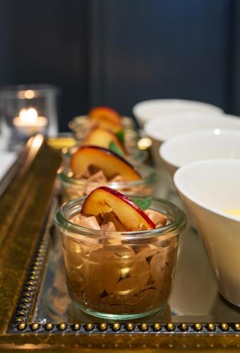 a tray with bowls of food on a table at Hotel & Gasthaus Die Perle in Perlen