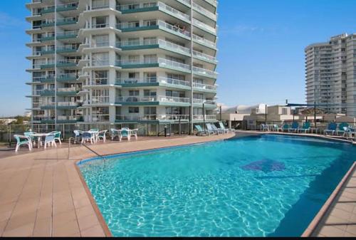 a large swimming pool in front of a large apartment building at Cooly Bliss Sub-penthouse in Gold Coast