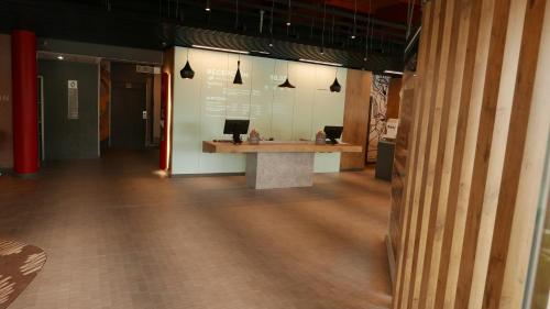 a lobby with a desk with a laptop on it at Ibis Hotel Alicante in Alicante