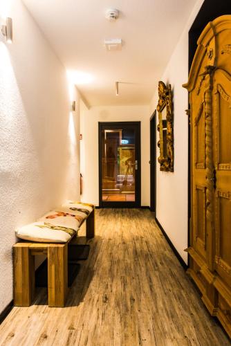 a corridor with benches in a room with wooden floors at Jagdschloss Windenhütte in Thale