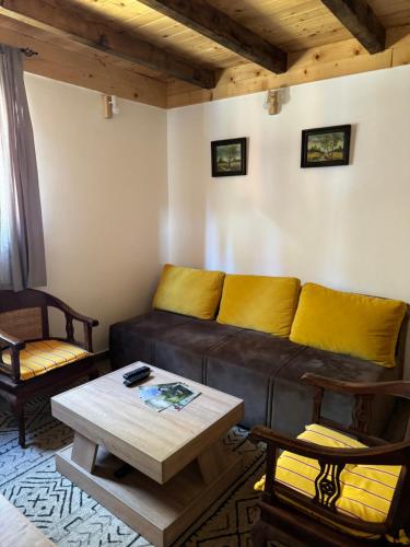 a living room with a couch and a table at Nest&Rest-Vikendice Tara in Sekulić 