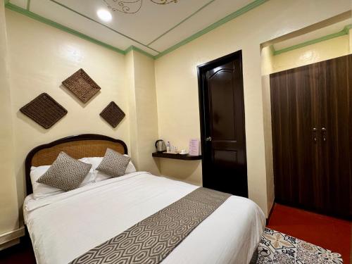 a bedroom with a bed and a black door at Park Avenue Boutique Hotel Manila in Manila