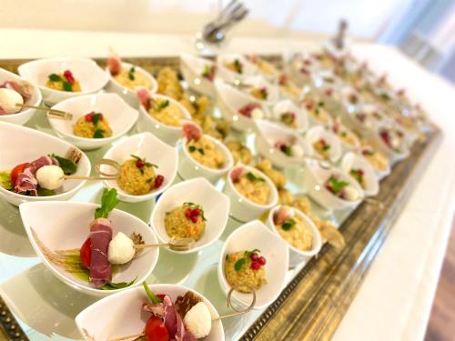 a buffet filled with plates of food on a table at Hotel & Gasthaus Die Perle in Perlen