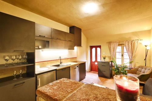 a kitchen with a table with a drink on it at Měšťanský dům - kulturní památka Mlýnská 119 in Jindrichuv Hradec