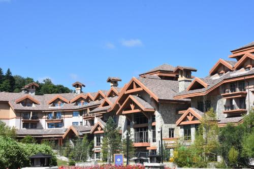 a row of apartment buildings with wooden roofs at Hyatt Regency Changbaishan in Fusong