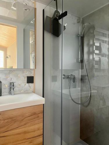 a bathroom with a shower and a sink at Lieblingsplatz Strandhotel in Sankt Peter-Ording